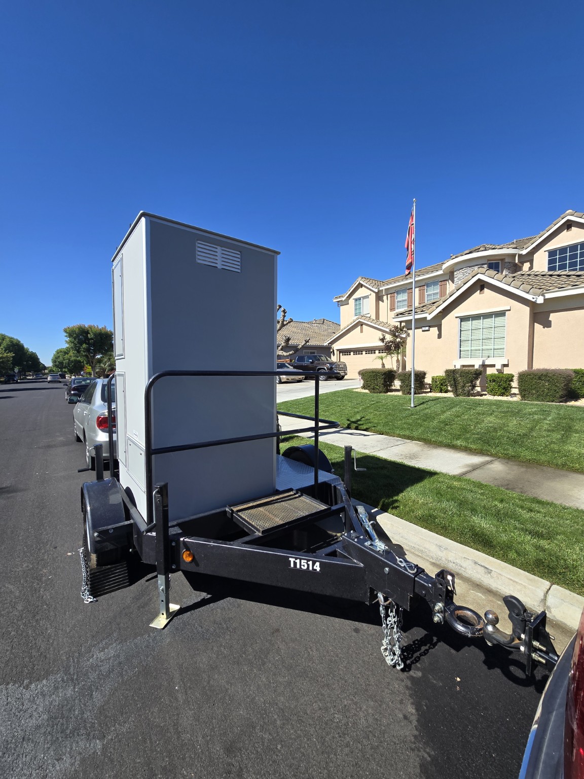 Solar Loo single-unit restroom trailer at a residential location